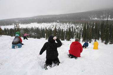 The kids take on Uncle Pat in a snowball fight.
