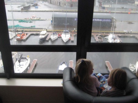 The girls watch the harbor from their livingroom window
