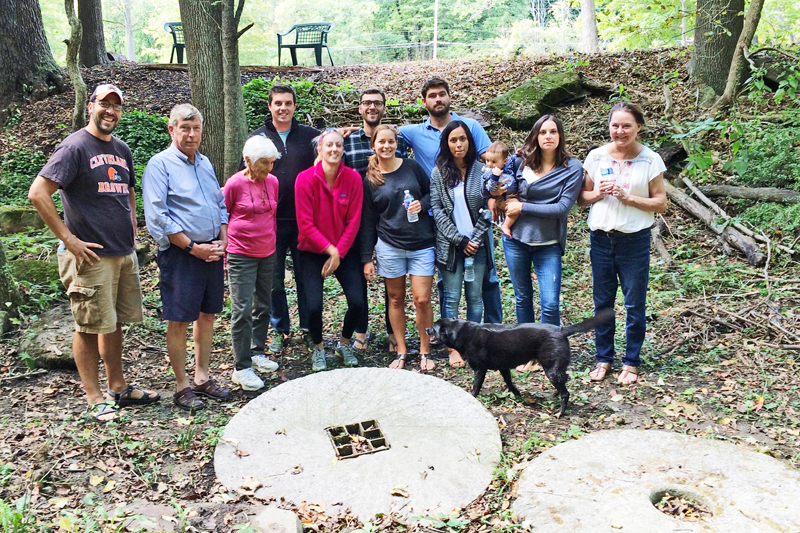 Our group of Henry's on the river bank just below Joan's house. These old millstones are still embedded along the river.